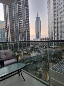 a balcony with a couch and a view of a city at Luxury 2 Bedroom Act 1 Apartment in Dubai