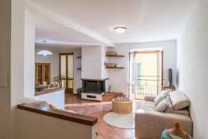 a living room with a couch and a fireplace at Casa Bar - Cozy Apartments Lake Como in Dongo