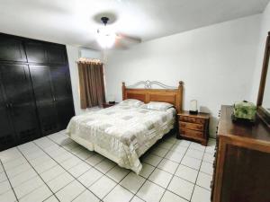 a bedroom with a bed and a ceiling fan at Casa Villa Serena 4 in San Carlos