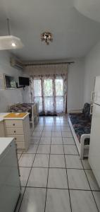 a kitchen with a large tiled floor in a room at Sunny Hemera Veta's House in Fourka