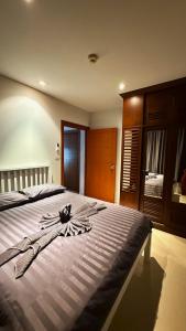 a bedroom with a large bed with clothes on it at Seaview Condominium A12 in Ban Tha Fat
