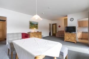 een woonkamer met een witte tafel en een tv bij Ferienwohnung Richter in Oberstdorf