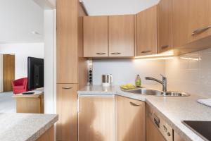 een keuken met houten kasten en een spoelbak bij Ferienwohnung Richter in Oberstdorf