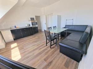 a living room with a couch and a table at Worker's Apartment in Leverkusen L1-4 in Leverkusen