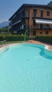 a large blue swimming pool in front of a building at Lake and Love - Lago D'Iseo in Sulzano