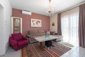 a living room with a couch and a red chair at Rural Holiday Home Endi in Lozovac