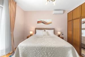 a bedroom with a large bed and two lamps at Rural Holiday Home Endi in Lozovac
