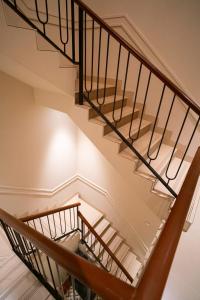 a staircase in a house with a wooden railingshiba at Casa Bonita Prime rose in Khanivde