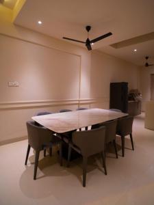a conference room with a wooden table and chairs at Casa Bonita Prime rose in Khanivde