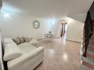 a living room with a white couch and a table at Casamilla in Procida