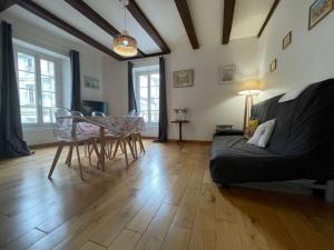 a living room with a table and chairs and a couch at Appt 3 pièces LA ROCHELLE - LR180-030 in La Rochelle