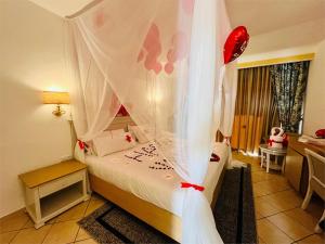 a bedroom with a bed with a canopy at Marhaba Royal Salem - Family Only in Sousse