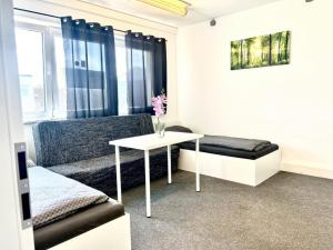 a living room with a couch and a table at Apart Residence KK in Glinde