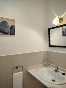 a bathroom with a sink and a mirror at Apartamentos Fariñas 11 in Sanlúcar de Barrameda +106 photos