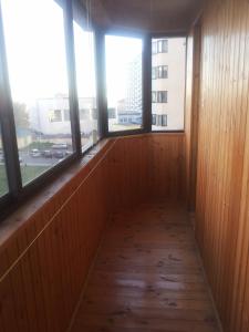 an empty room with three windows in a building at SavTim Apartaments in Mogilev