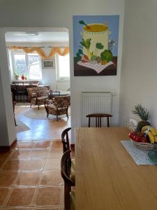 a dining room with a table and a living room at Belvedere Kremnica in Kremnica