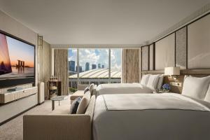 a hotel room with two beds and a large window at Marina Bay Sands in Singapore