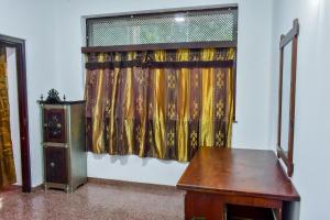 a room with a curtain and a wooden table at Wicks Backpacker's Lodge - Peaceful Quality stay, Walk to the Historic Galle Dutch Fort and the beach in Galle +53 photos