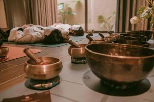 a row of copper bowls sitting on a counter at Mandala Retreats Kim Bôi in Hòa Bình +38 photos