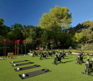 a group of people playing golf in a field at Meliá Cala Galdana in Cala Galdana