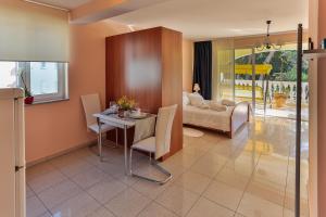 a living room with a table and a couch at Apartments Dora in Medulin