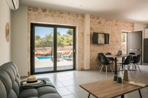 a living room with a couch and a table at Petradi Villa Skala I in Skala
