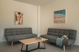 a living room with two couches and a coffee table at Petradi Villa Skala I in Skala