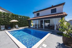 a villa with a swimming pool and a house at Villa Bavaria in Galižana