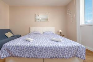 a bedroom with a bed with two pillows on it at Apartment Oasis with Sea View in Zadar