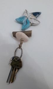 a bunch of keys on a key chain with a bird on it at Harmonia Beach House in Kimolos