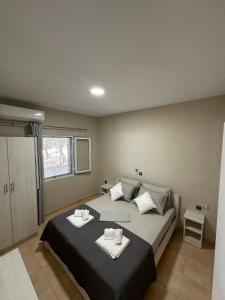 a bedroom with a large bed with two towels on it at Villa Nicole in Katarrákhion