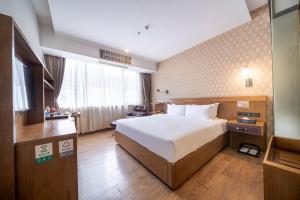 Voodi või voodid majutusasutuse Xicheng International Hotel Guangzhou Sanyuanli Jiangxia Metro Station Branch toas