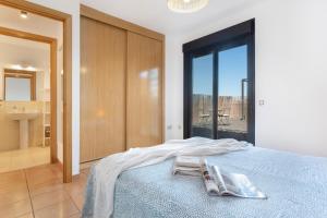 a bedroom with a bed with two towels on it at Sweet Home Majanicho in Majanicho +36 photos