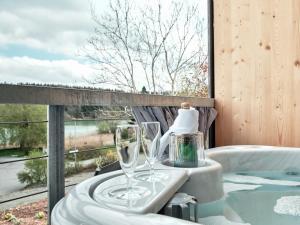 a bath tub with two wine glasses on a balcony at Ferienhaus Fischer Wagenhausen in Bad Saulgau +28 photos