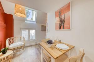 a kitchen and dining room with a table and chairs at Terracotta in Carrières-sous-Poissy
