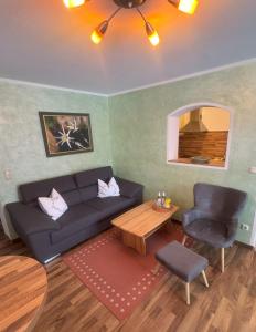 a living room with a couch and a table at Ferienwohnungen Martinsklause in Ramsau