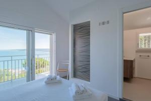 a white kitchen with a view of the ocean at Villa Elvise - YourPlace Abruzzo in Fossacesia +47 photos