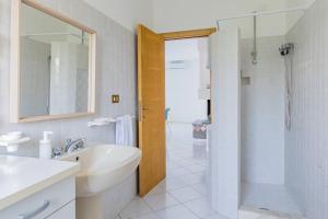 a white bathroom with a sink and a shower at Ferrante - YourPlace Abruzzo in Fossacesia