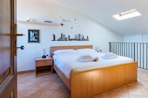 a bedroom with a large bed with towels on it at La casetta di Nonna Nice - YourPlace Abruzzo in Rocca San Giovanni