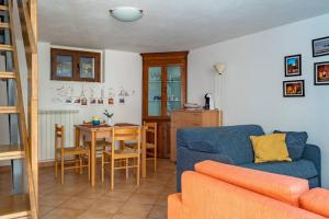 a living room with a blue couch and a table at La casetta di Nonna Nice - YourPlace Abruzzo in Rocca San Giovanni +9 photos