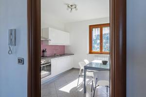 a kitchen with a table and a table and chairs at La costa 75 - YourPlace Abruzzo in Marina San Vito +7 photos