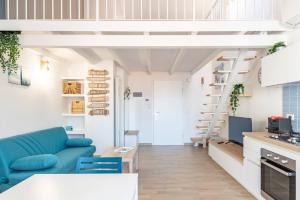 a small apartment with a blue couch and a kitchen at Blu Mare - YourPlace Abruzzo in Marina San Vito