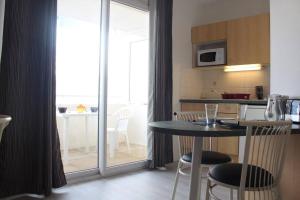 a kitchen and dining room with a table and chairs at Appt Studio LA ROCHELLE - LR030-A119Z in La Rochelle