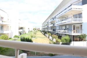 an apartment balcony with a view of a courtyard at Appt Studio LA ROCHELLE - LR030-A119Z in La Rochelle