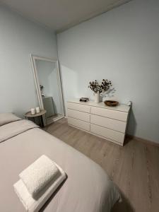 a bedroom with a bed and a dresser with a mirror at Apart Canada Center in Baia Mare
