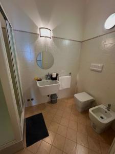 a bathroom with a sink and a toilet and a mirror at Regina d’Aragona casa vacanze in Sulmona +37 photos