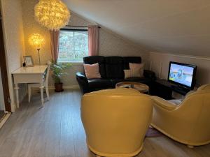 a living room with a couch and a table at Fagerbacka Svit. Trivsam lägenhet nära havet in Lysekil
