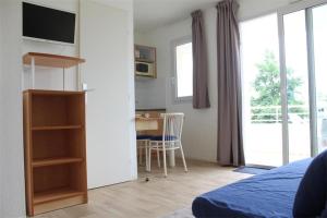 a bedroom with a bed and a desk and a table at Appt 2 pièces LA ROCHELLE - LR030-E116 in La Rochelle