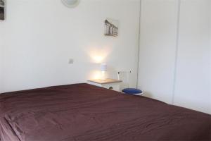 a bedroom with a bed and a table with a lamp at Appt 2 pièces LA ROCHELLE - LR030-E116 in La Rochelle