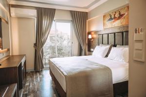 a hotel room with a large bed and a window at Venezia Alaçatı in Yumru +27 photos